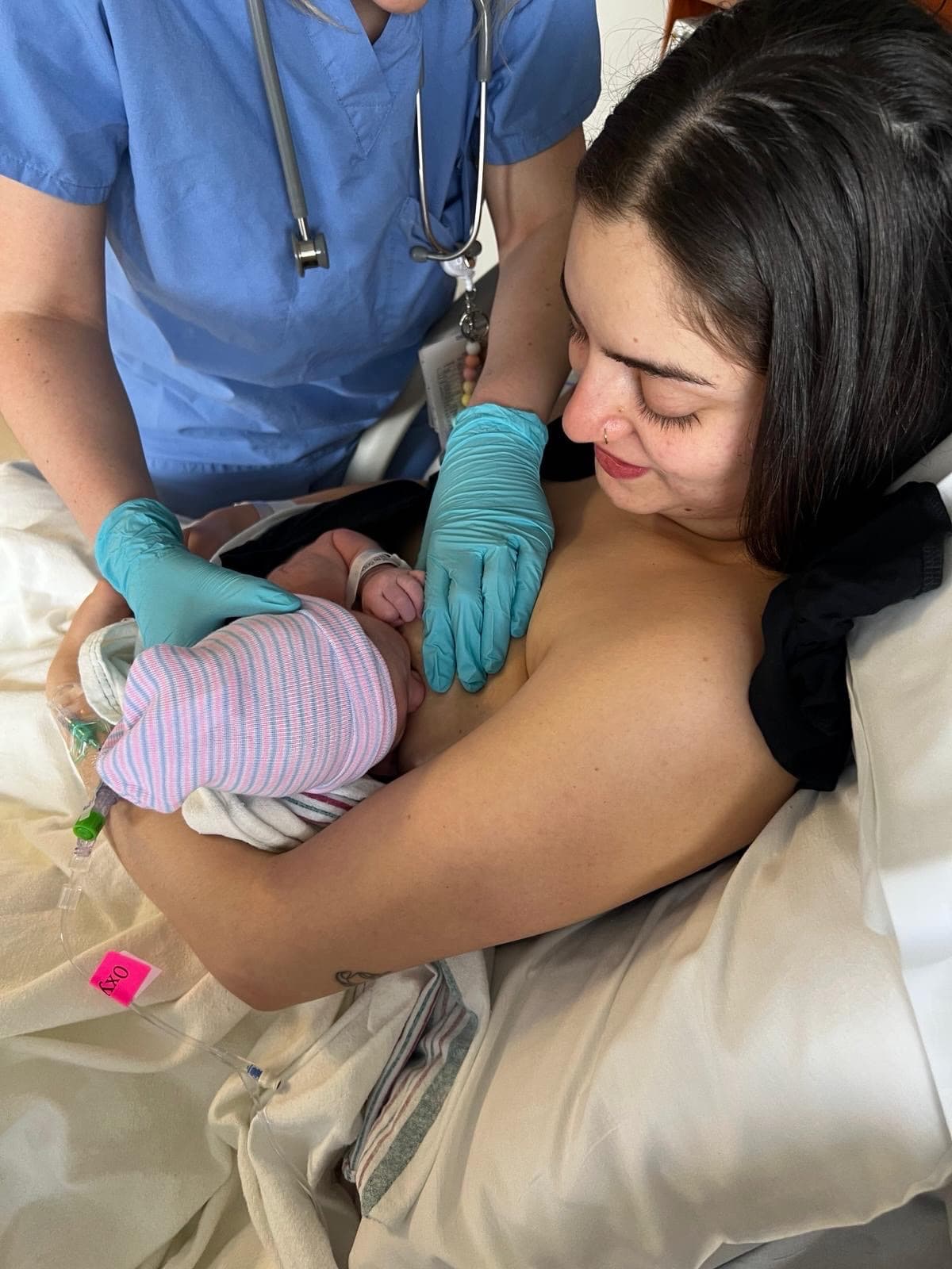 A parent holding their newborn after a hospital birth